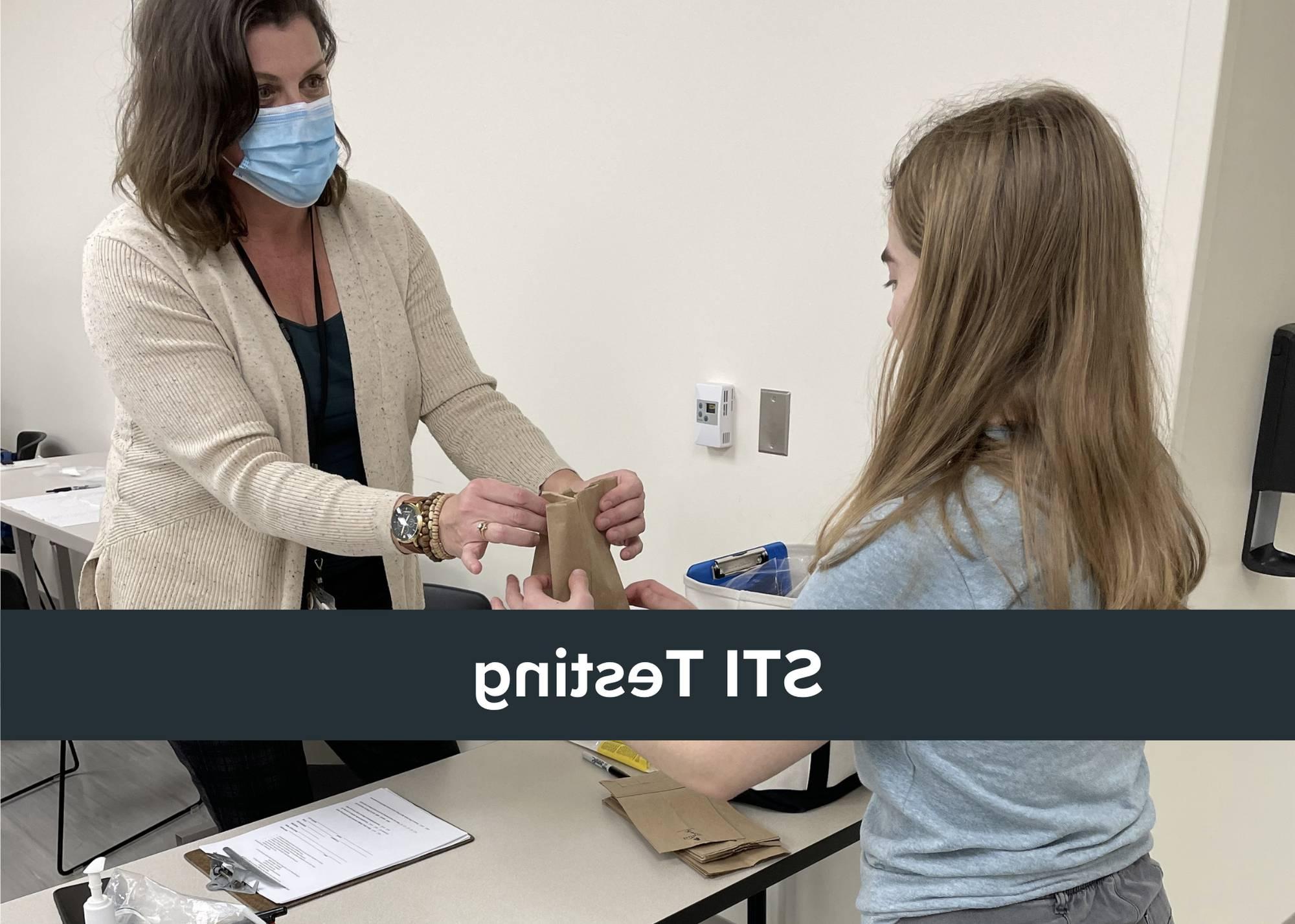 Says "STI testing" with photo of someone taking paper bag from health care provider